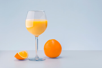 Fresh orange juice with fruits on gray background with copy space.