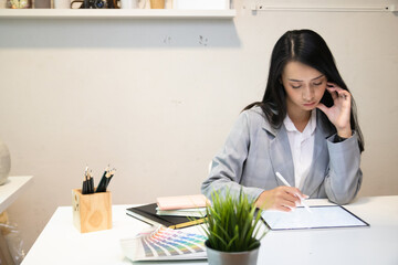 Cropped shot of two UI developers meeting on their project with paperwork and tablet on meeting...