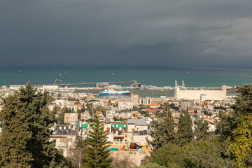 Naklejka premium View on a rainy day from Mount Carmel to the downtown, the port and the Mediterranean Sea and Haifa city, in Israel.