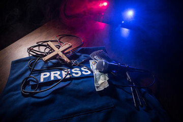 Fototapeta na wymiar Media Journalism fake news concept. Blue journalist (press) vest in dark with backlight and fog. Puppeteer controls media.