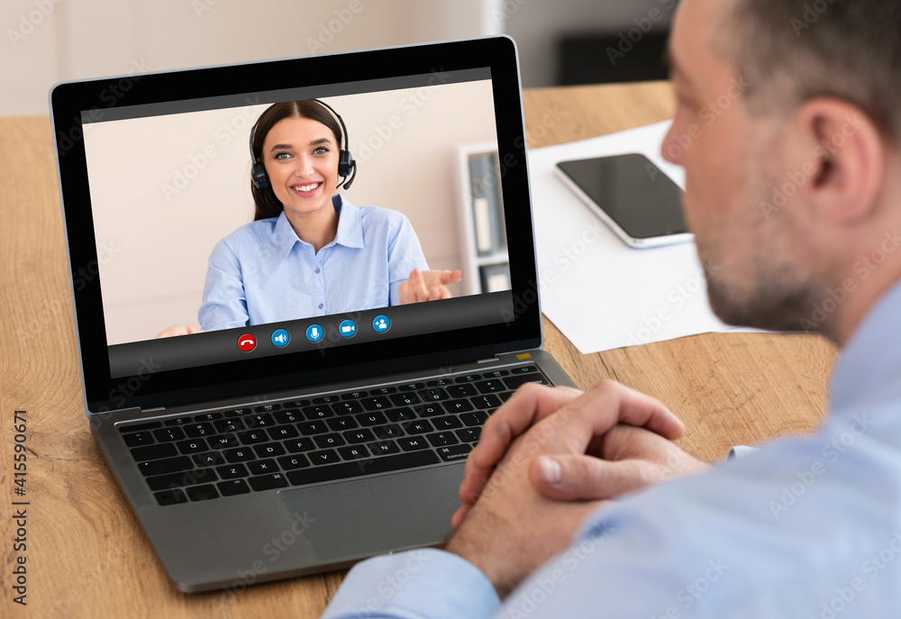 Sticker Rear View Of A Businessman Videoconferencing With Female Colleague Via Laptop Computer