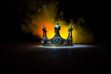 low key image of beautiful queen/king crown over wooden table. vintage filtered. fantasy medieval...