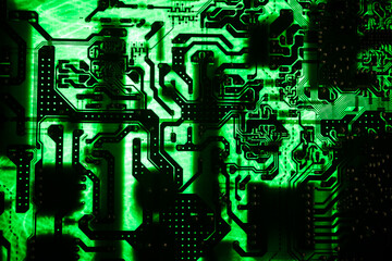 Stylized photo of an electronic microcircuit. Microcircuit, contacts, electronics, motherboard. Black background. Macro photography of electronic devices.