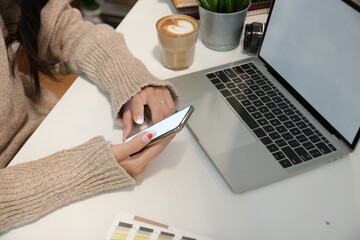 Cropped shot of two UI developers meeting on their project with paperwork and tablet on meeting...