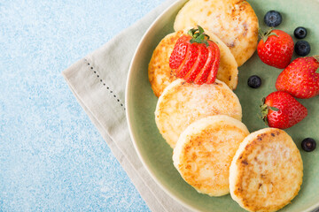 Homemade fried cheesecakes with condensed milk and berries, top view
