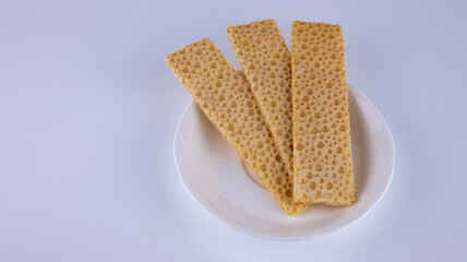 fitness crispbreads lie in a white plate, isolated