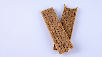 bitten off rye fitness crispbread on a white background