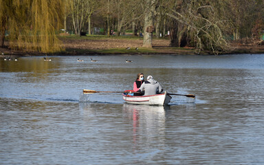 Mature couple wearing anti-covid face mask during a rawboat trip on the lake Daumesnil in the Bois de vincennes, Paris, FRANCE. 
