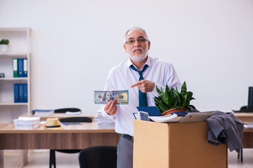 Old male employee being fired from his work in retirement concept