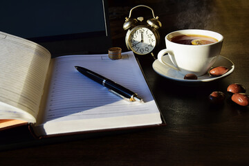 Remote online work, business concept laptop with diary and a cup of tea.