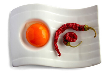 isolated background, top view, plate of food ingredients with fresh egg yolk and  piri piri