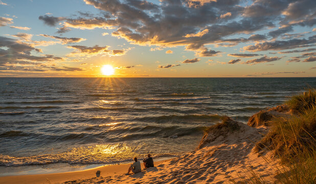 Couple watching the gorgeous Sunset on the Beach on Lake Michigan - Ludington at Stearns Park and Ludington State Park