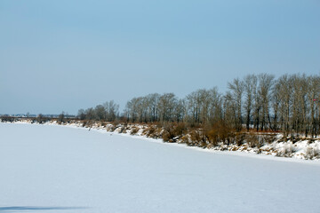 Winter snowy river landscape. Frozen ice on the river