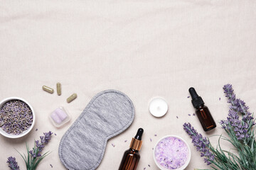 Sleep mask and lavender products for healthy sleep on textile background. Healthy night sleep...