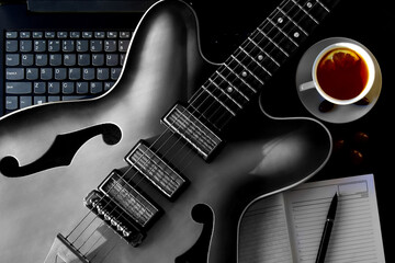 Acoustic guitar and notebook with diary online guitar lessons at home.