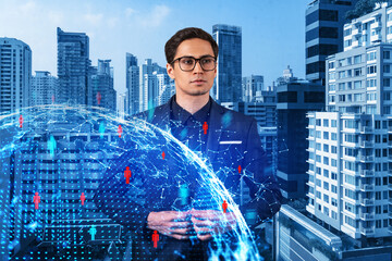 Handsome eastern HR director at international company is thinking about efficient strategy to recruit highly qualified specialists. Social media and marketing hologram icons over Bangkok background.