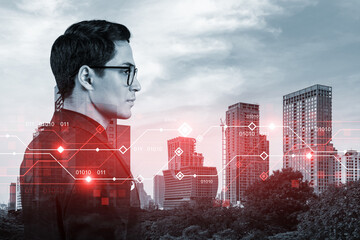Eastern young businessman pondering on technology at business process to achieve tremendous growth in commerce. Worldwide process to conduct transactions. Tech hologram icons over Bangkok background