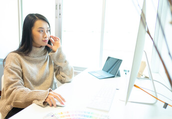 Cropped shot of two UI developers meeting on their project with paperwork and tablet on meeting...