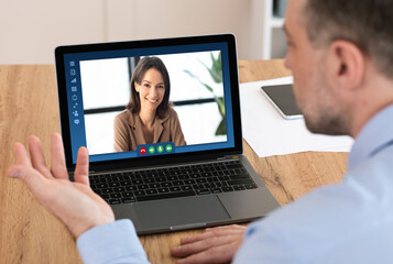 Fototapeta na wymiar Male entrepereneur using laptop computer in office for online business meeting