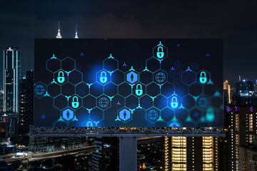Padlock icon hologram on road billboard over panorama city view of Kuala Lumpur at night to protect...