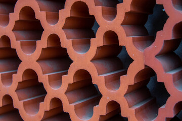 Close-up of bricks. Close-up of a fence of ornamental bricks, tiles. Abstract geometric composition