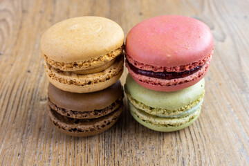 close up of fresh colorful macarons, raspberry, hazelnut, pistachio