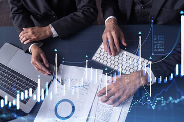 Two traders man and woman researching historic data to predict stock market behavior. Internet...