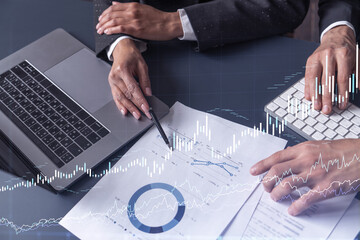 Two traders man and woman researching historic data to predict stock market behavior. Internet...