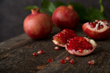 Fresh ripe pomegranate on a wooden background, selective focus