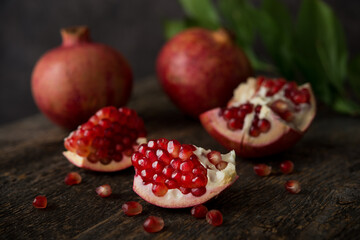 Obraz na płótnie Canvas Fresh ripe pomegranate on a wooden background