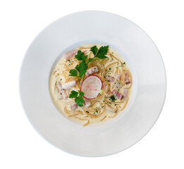 Italian pasta spaghetti carbonara with fried bacon in ceramic plate top view isolated on white background, clipping path included