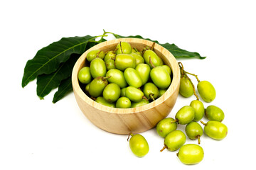Fresh Neem fruit on wooden bowl isolated on white background. Neem fruit is an excellent moisturizing and contains various compounds that have insecticidal and medicinal properties.