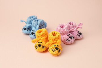 Pregnancy motherhood perenthood concept, Three pairs of baby booties funny bunny rabbit design on pink background, baby shower, first birthday party banner, daycare, kindergarten, day nursery