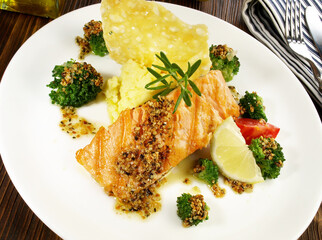 Grilled Salmon Steak with Broccoli, mashed Potatoes Cheese Cracker on wooden Background