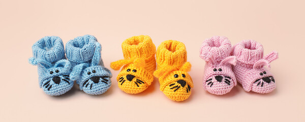 Pregnancy motherhood perenthood concept, Three pairs of baby booties funny bunny rabbit design on pink background, baby shower, first birthday party banner, daycare, kindergarten, day nursery