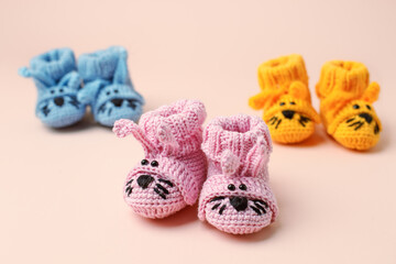 Pregnancy motherhood perenthood concept, Three pairs of baby booties funny bunny rabbit design on pink background, baby shower, first birthday party banner, daycare, kindergarten, day nursery