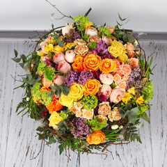 Flower arrangement with roses, lilac and alstroemeria