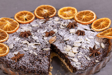 Tart with poppy seeds and fruit sprinkled with powdered sugar