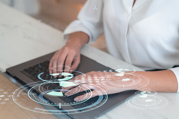 Woman typing the keyboard to create innovative software to change the world and provide a completely new service. Close up shot. Hologram tech graphs. Concept of Dev team. Formal wear.