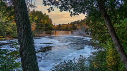 Pre dawn blue hour peak through of Upper Tahquamenon Falls in Autumn - Michigan State Park in the Upper Peninsula - waterfall