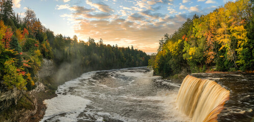 Spectacular sunrise shining on the Upper Tahquamenon Falls in Autumn - Michigan State Park in the Upper Peninsula - waterfall