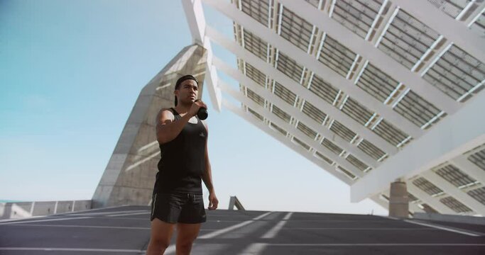 Young Fit Athlete Exhausted Taking Break and Drinking Water After Workout Exercising Outdoor in City Background. Exercising Strength, Cardio and Power. Sport Healthy Lifestyle Concept
