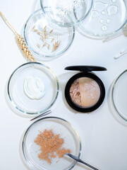 Eco-friendly and useful decorative cosmetics, concept. Powder and various ingredients in bottles