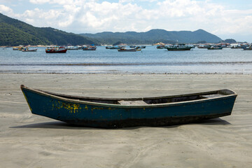 Naklejka na ściany i meble fishing boat on the beach with blue sky