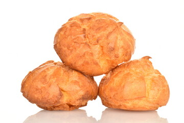 Several fresh fragrant chouquettes, on a white background.