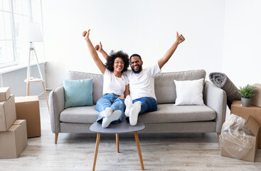 Black Spouses Celebrating Moving Day In New House, Gesturing Thumbs-Up