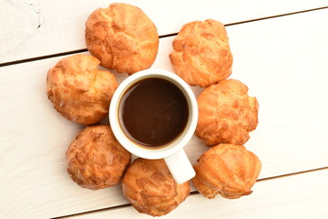 Several fresh fragrant chouquettes, on a white background.