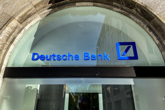 Deutsche Bank logo on the window of a branch in Munich, Germany