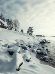 Ice coast on the water in Lake Ladoga with fresh snow in winter
