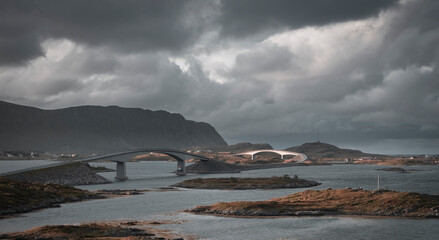 Fredvang bridge and the surrounding mountains and sea on the Lofoten Islands Norway in autumn under gloomy clouds